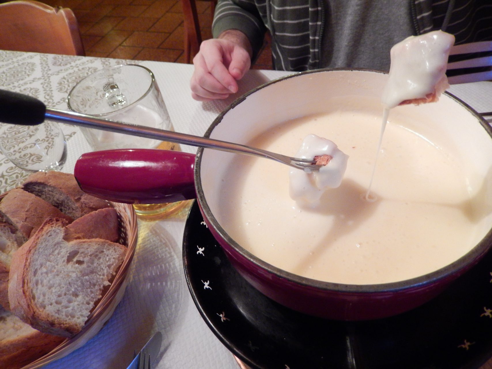 Eating Gruyère cheese fondue in Gruyères medieval village